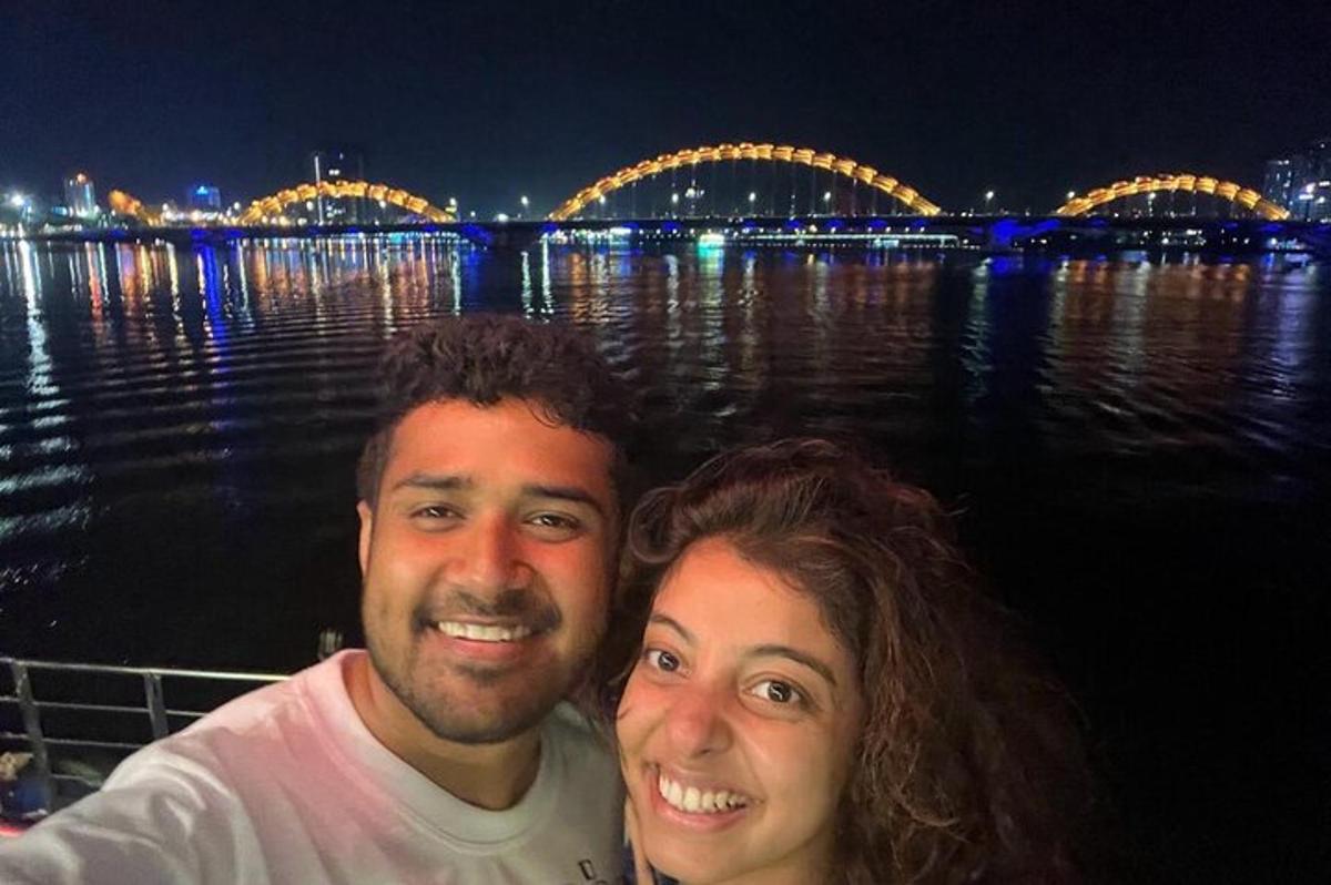 a man and a woman standing on a boat in the water