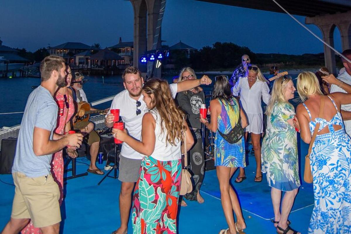 a group of people standing on a deck at a party