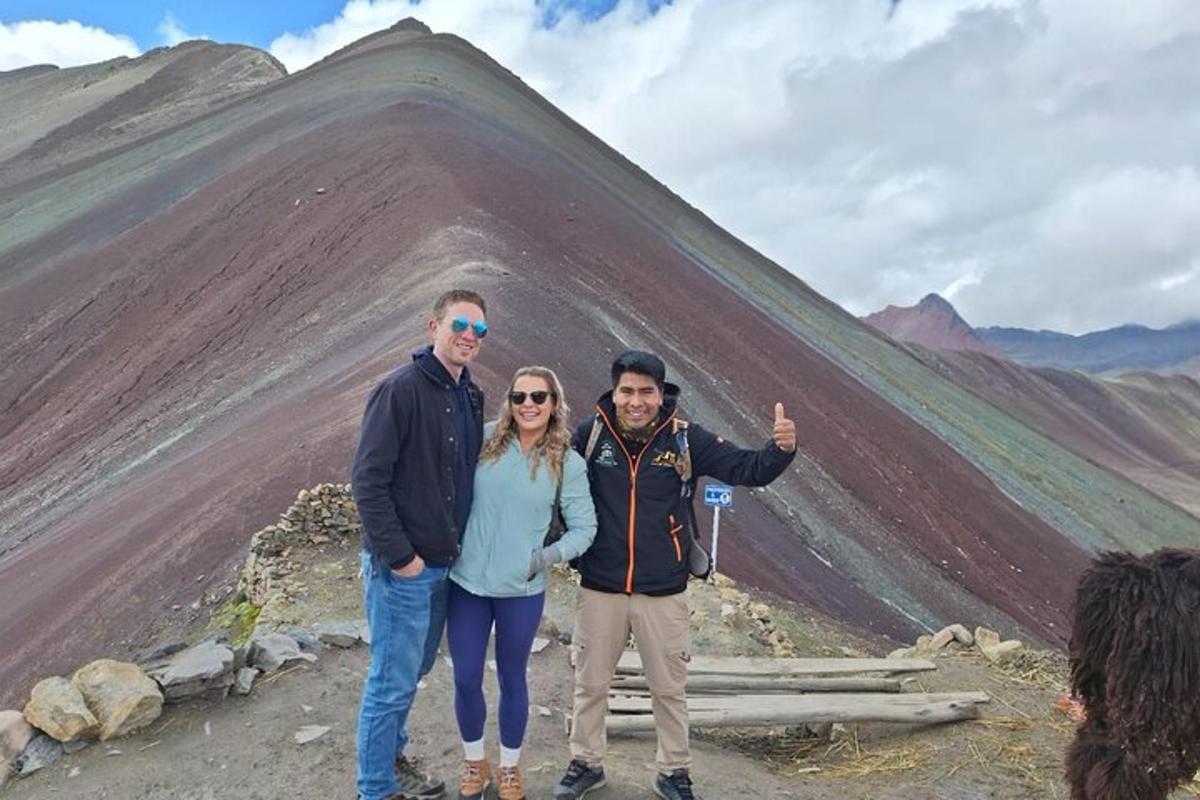 a group of people standing in front of a mountain