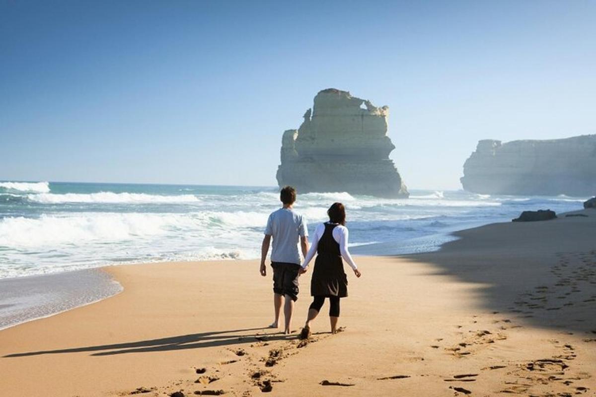 a man and a woman walking on the beach