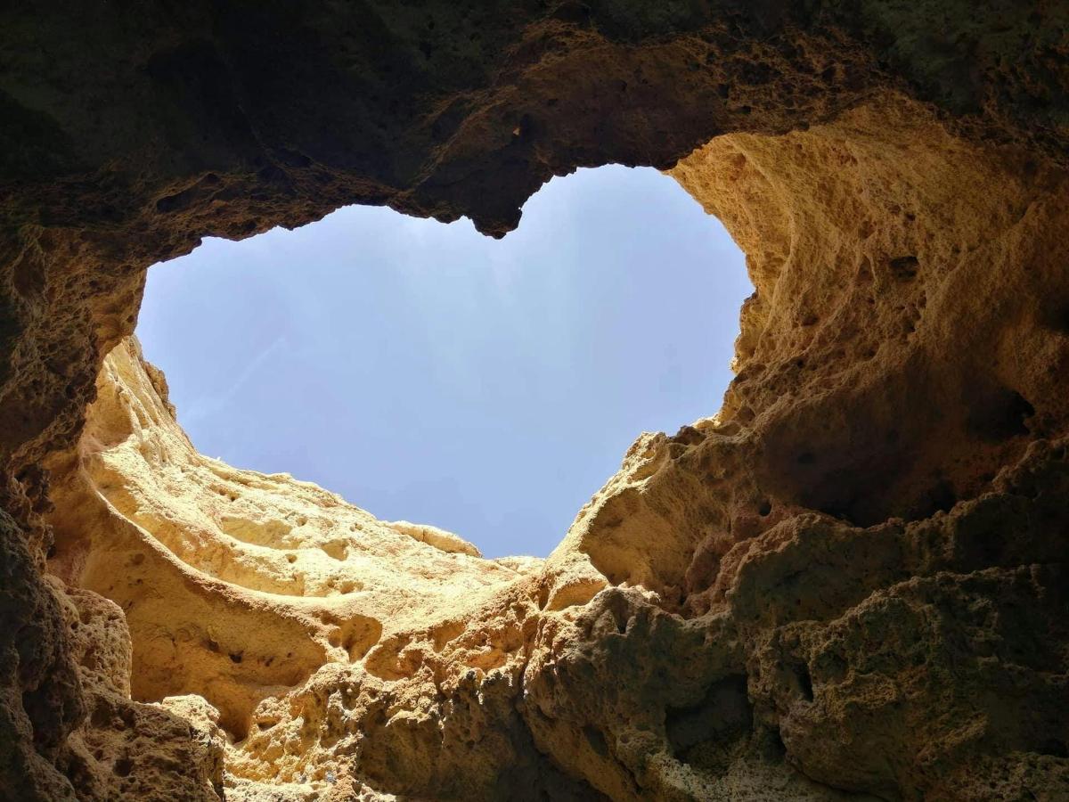 a view of the sky through a rock formation