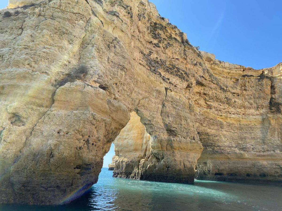 a rock wall in the water next to the ocean