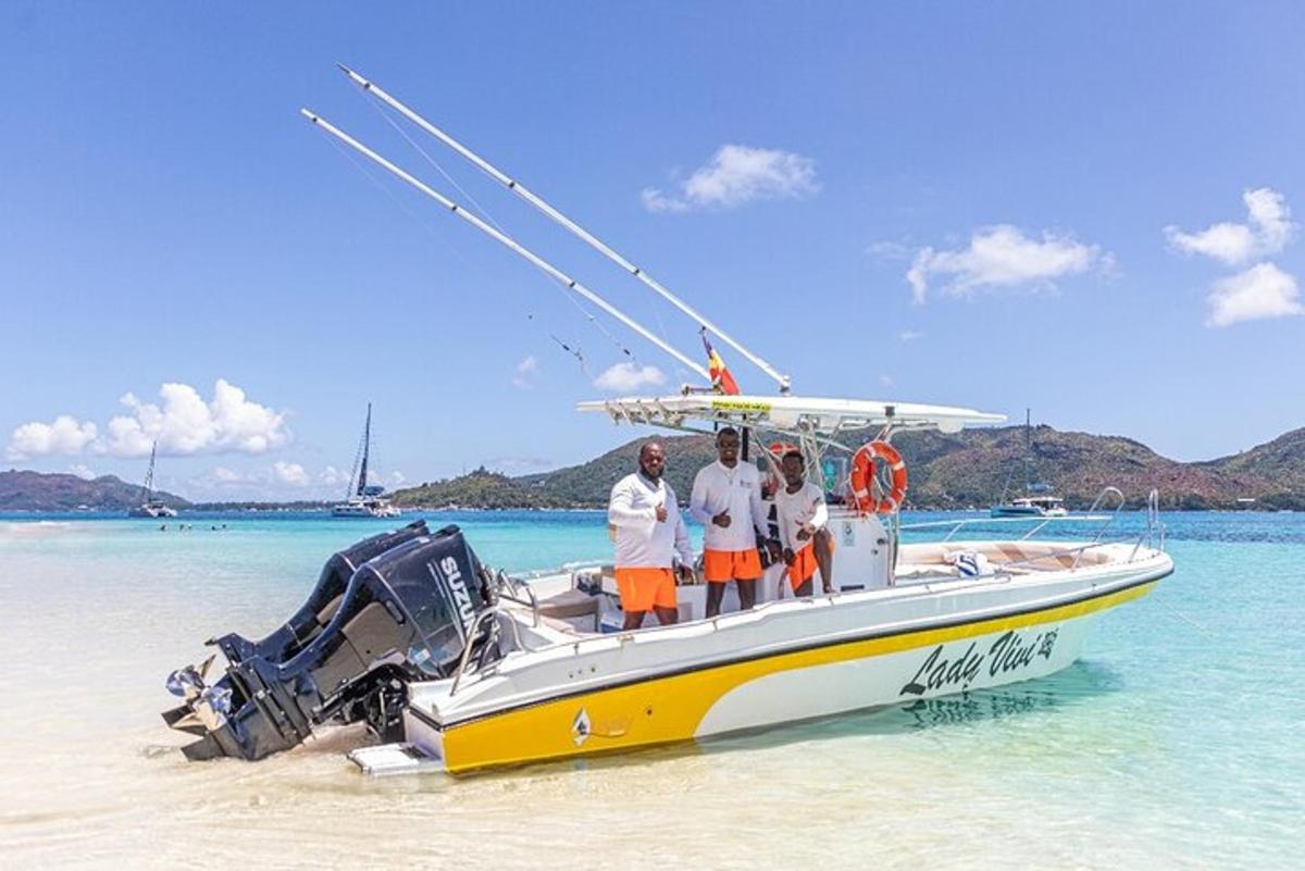 three people standing on a boat on the beach