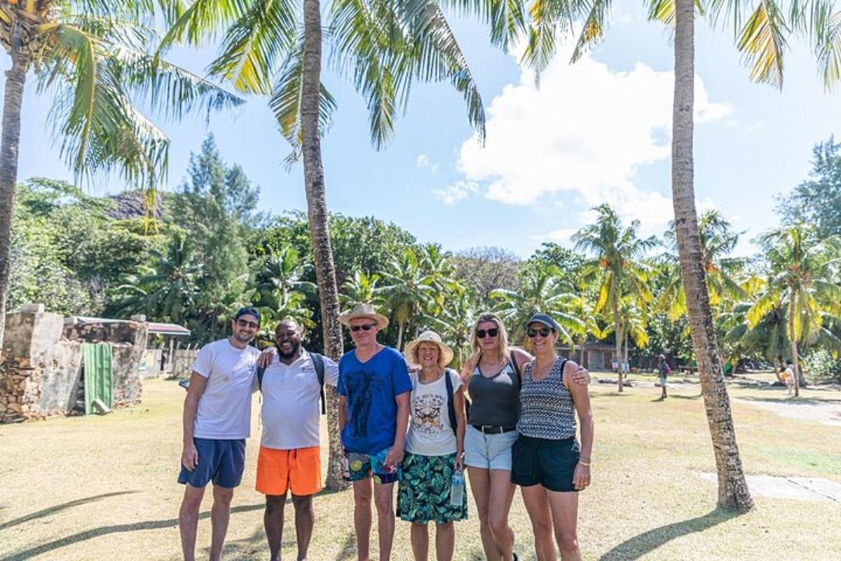 a group of people standing in front of palm trees