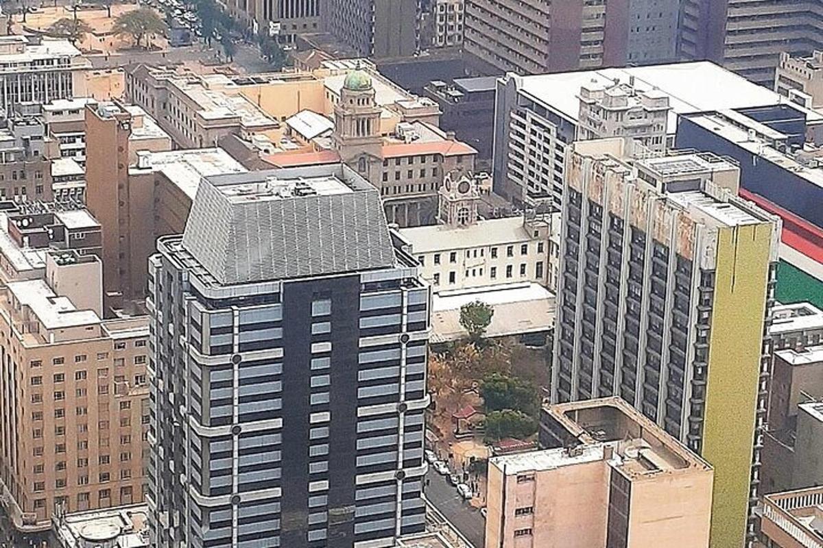 an aerial view of a city with tall buildings