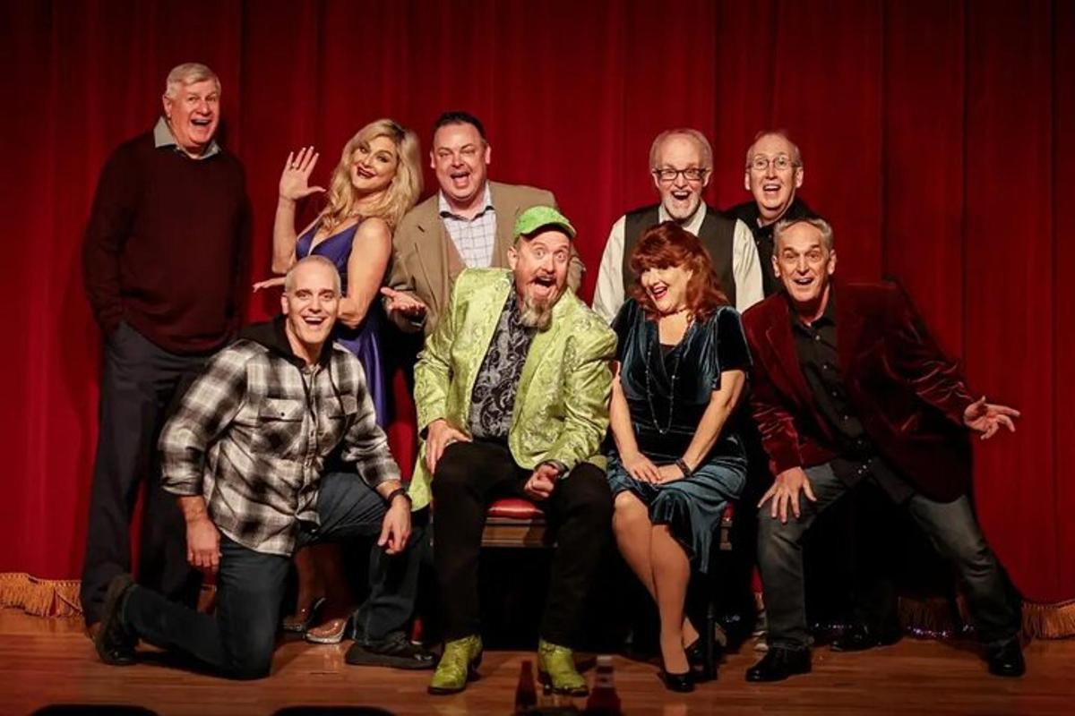 a group of people posing for a picture on a stage