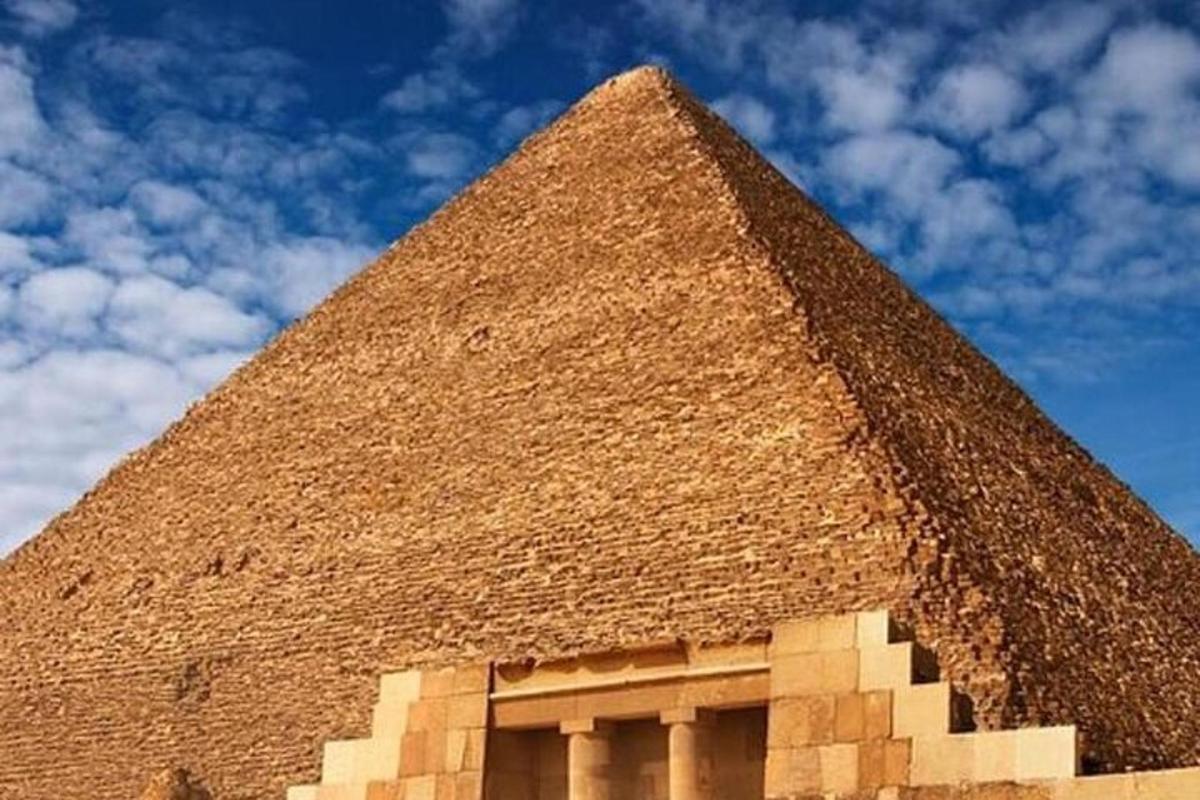 a pyramid with a blue sky in the background