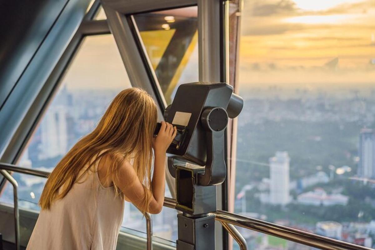 a woman taking a picture of a city with a camera