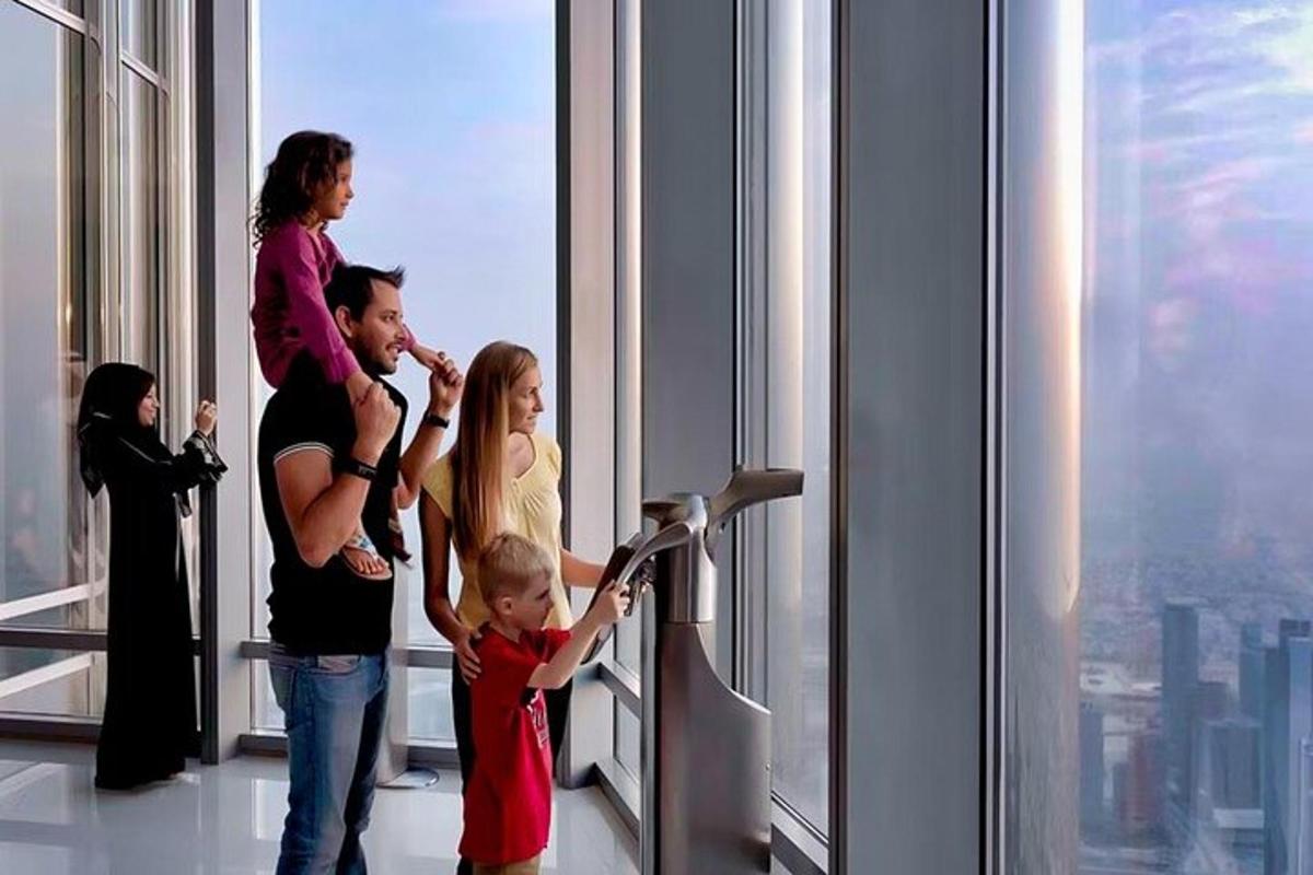 a family standing in front of a window in a skyscraper