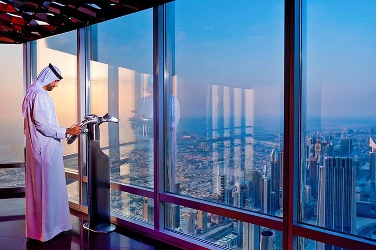 a man looking out the window of a skyscraper
