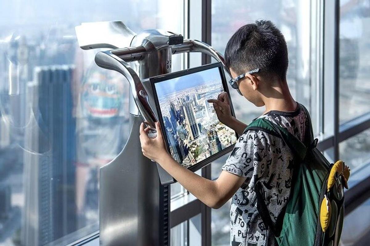 a young boy in an office looking at a television