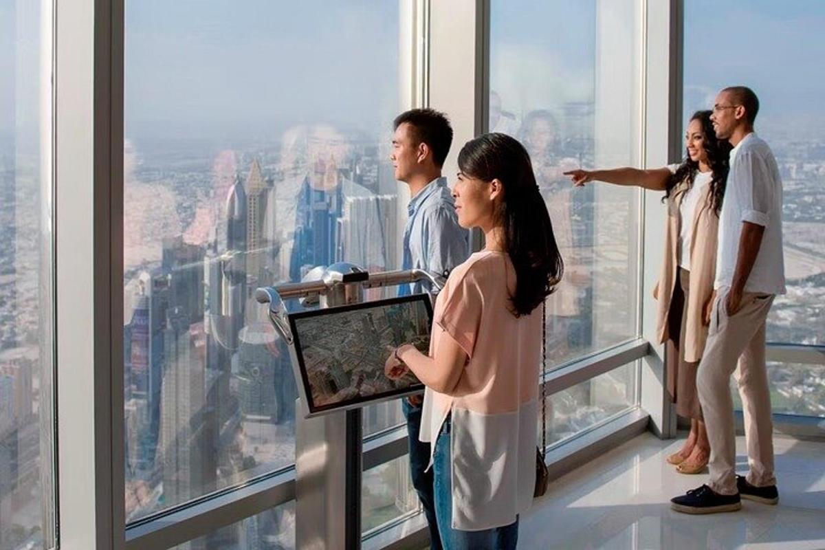 a group of people standing in the observation deck of a skyscraper