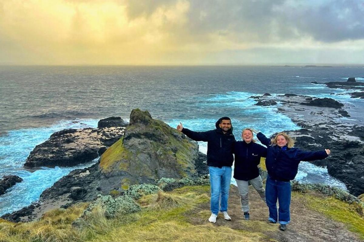 a group of people standing on top of a rock