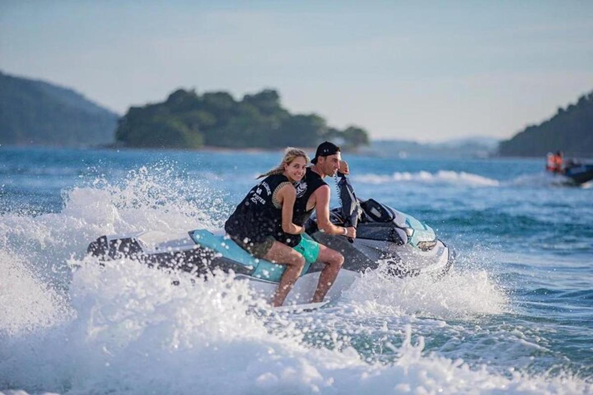 a man and woman riding a jet ski in the water