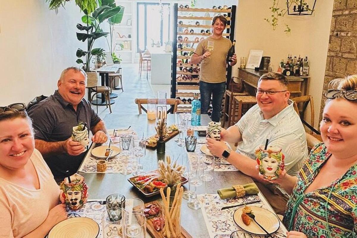 hópur fólks situr við borð með grímur