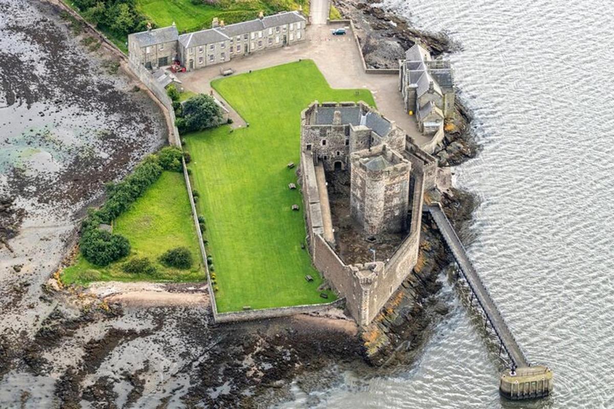 an aerial view of a castle in the water