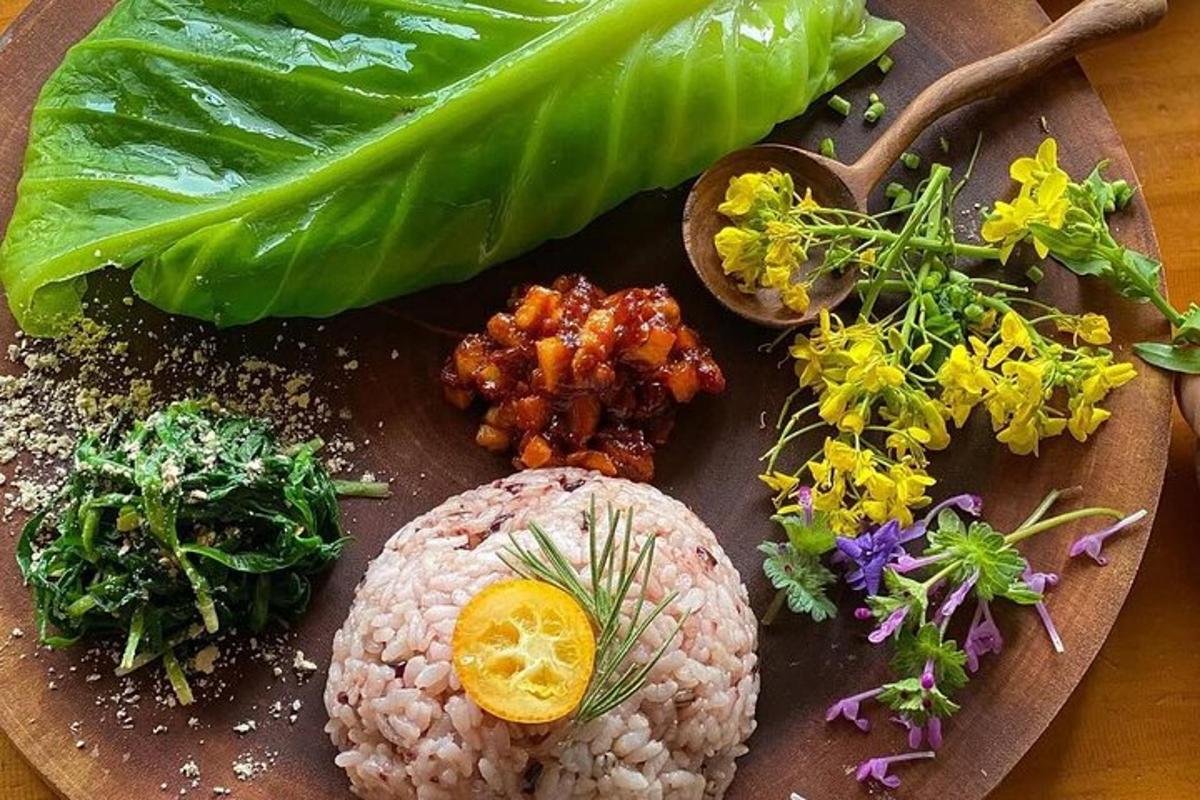 một đĩa thức ăn với cơm và rau trên bàn