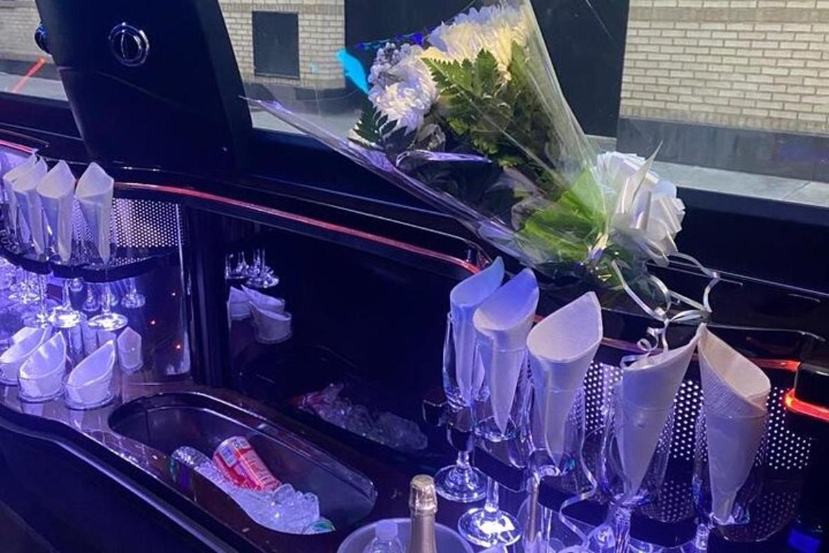 a sink with a bunch of wine glasses and flowers
