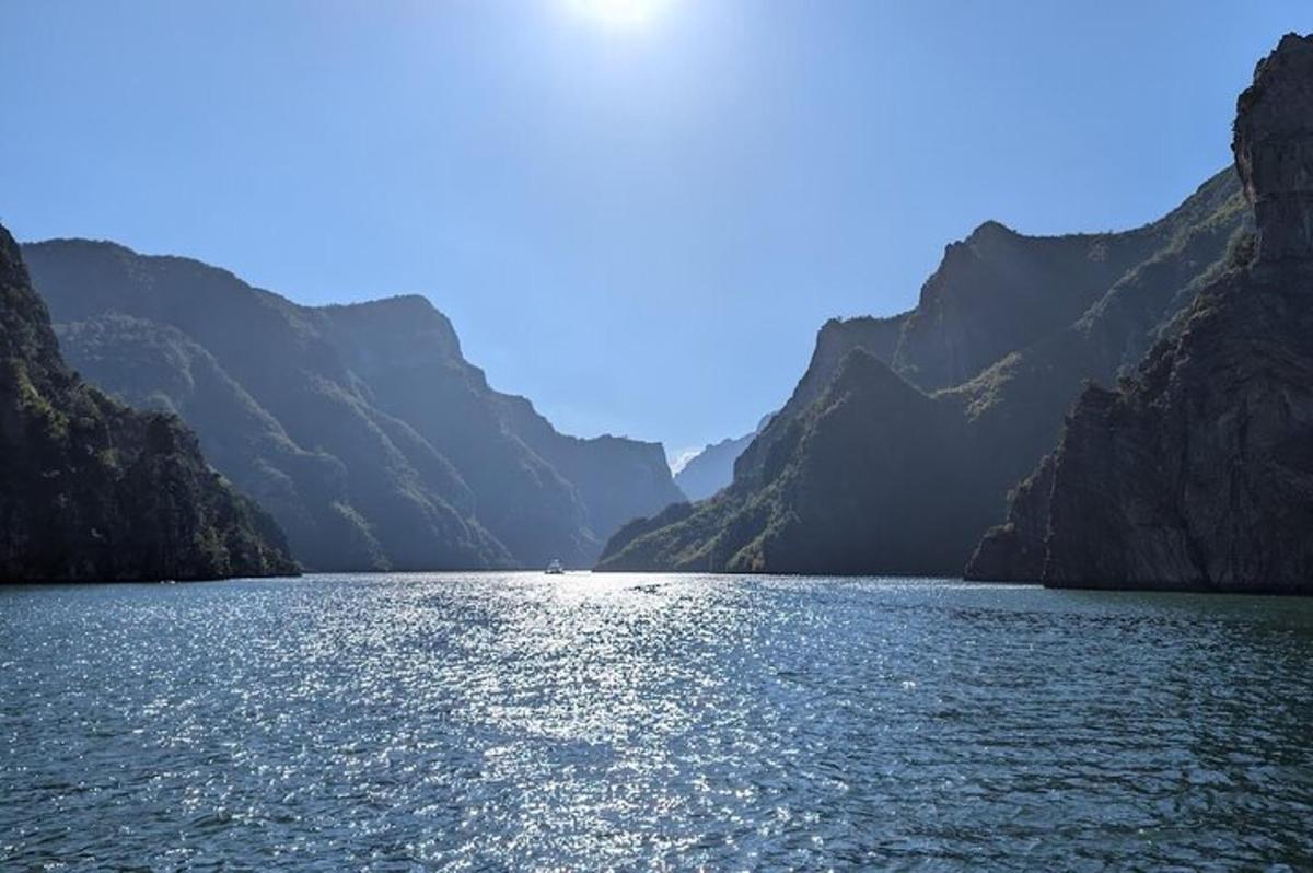 a boat in a large body of water with mountains