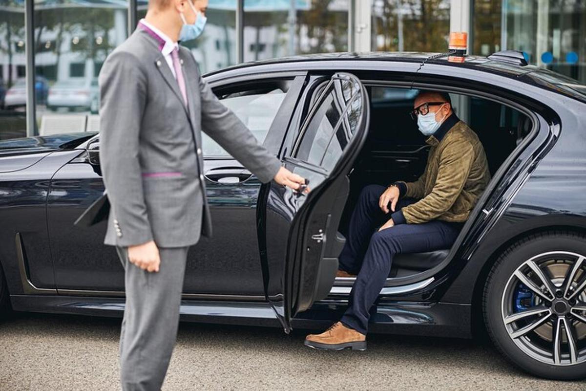 a man wearing a mask standing next to a car