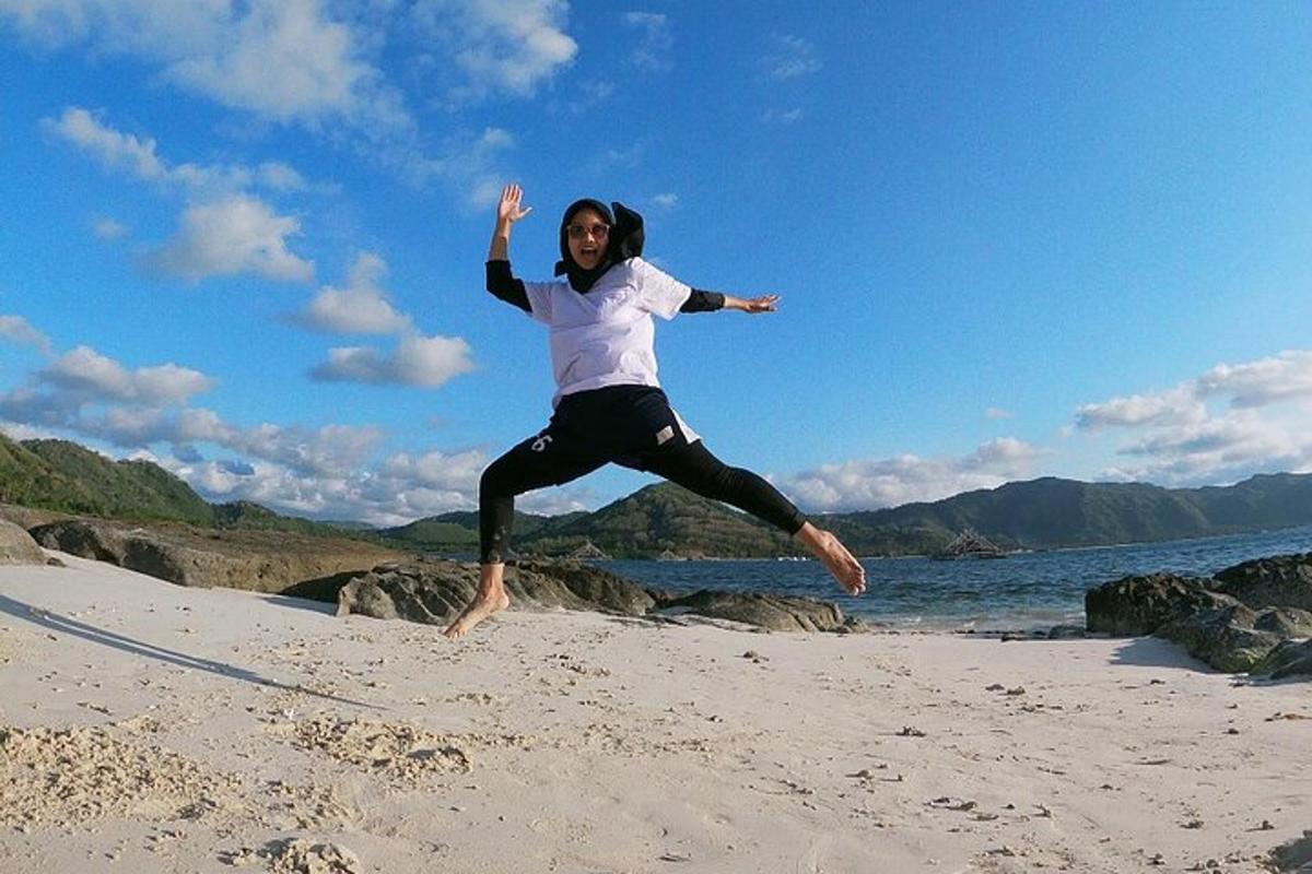 a woman jumping in the air on a beach