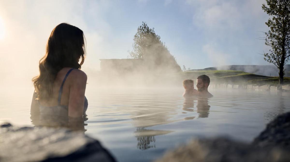 a group of people in the water at the geothermal spa