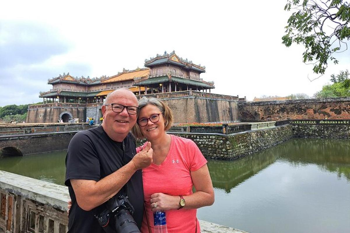 a man and a woman standing in front of a building