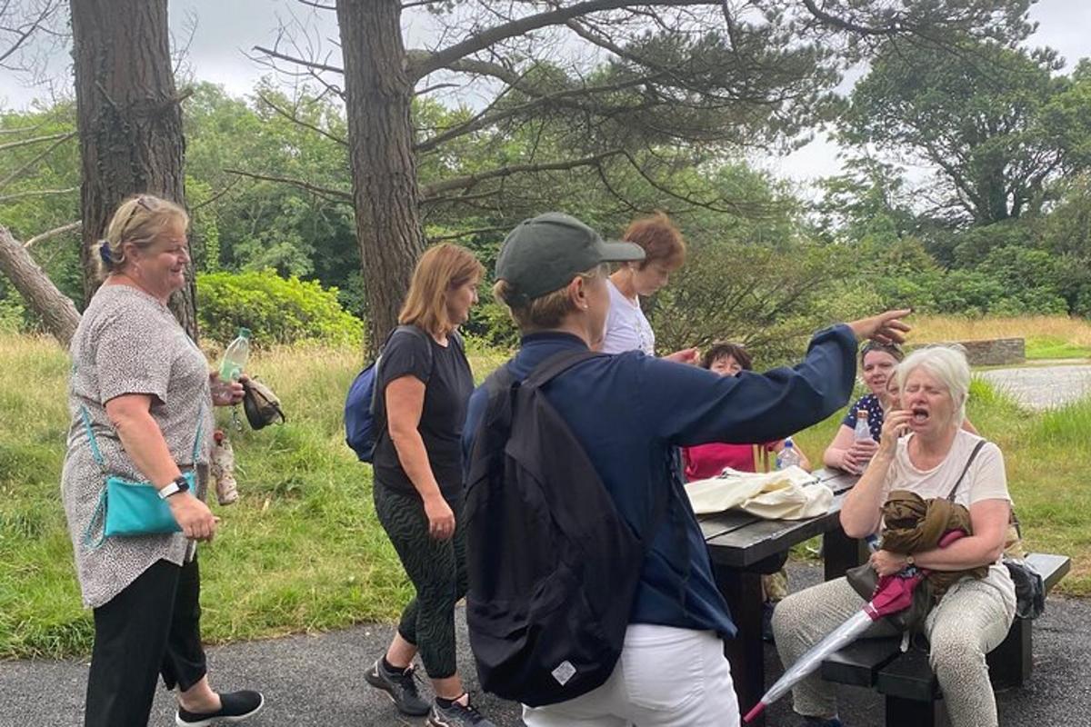 a group of people standing around a picnic table
