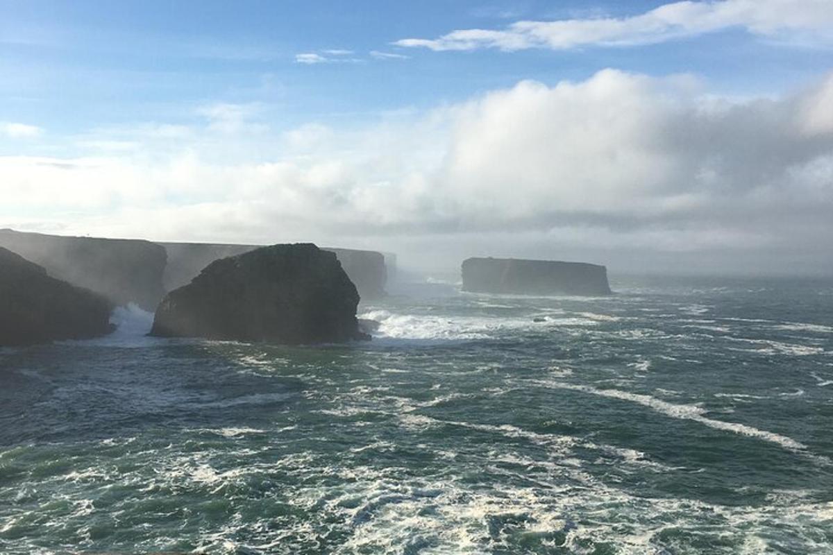 a view of two large cliffs in the ocean