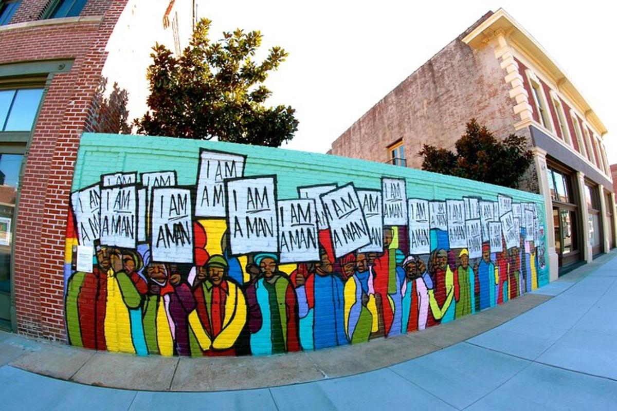 a mural of a group of people holding signs