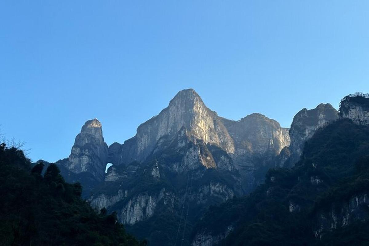 a group of mountains with the sun shining on them