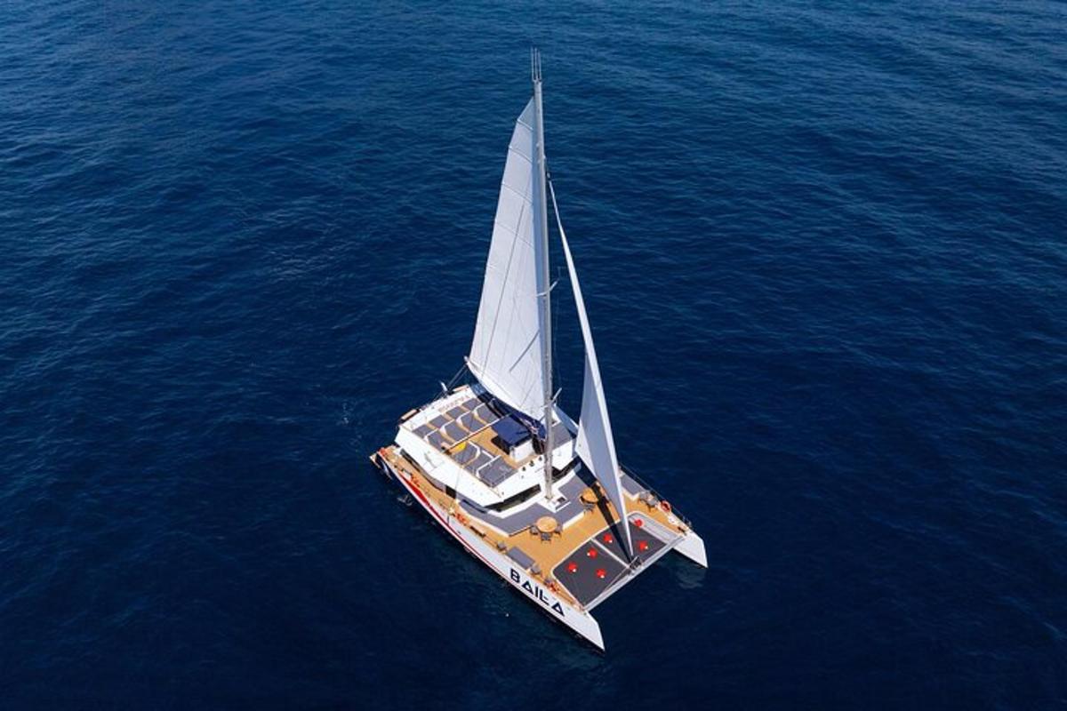 a boat with a large sail in the water