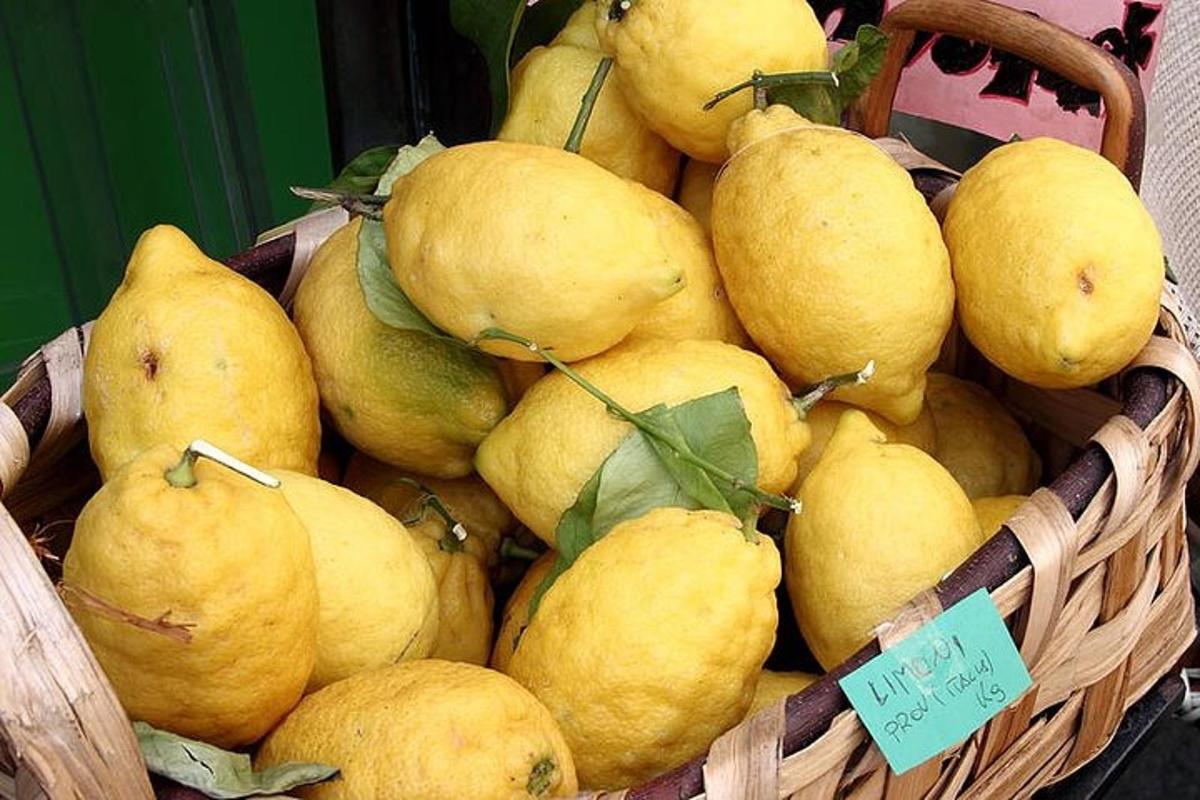 a basket full of yellow lemons on a table