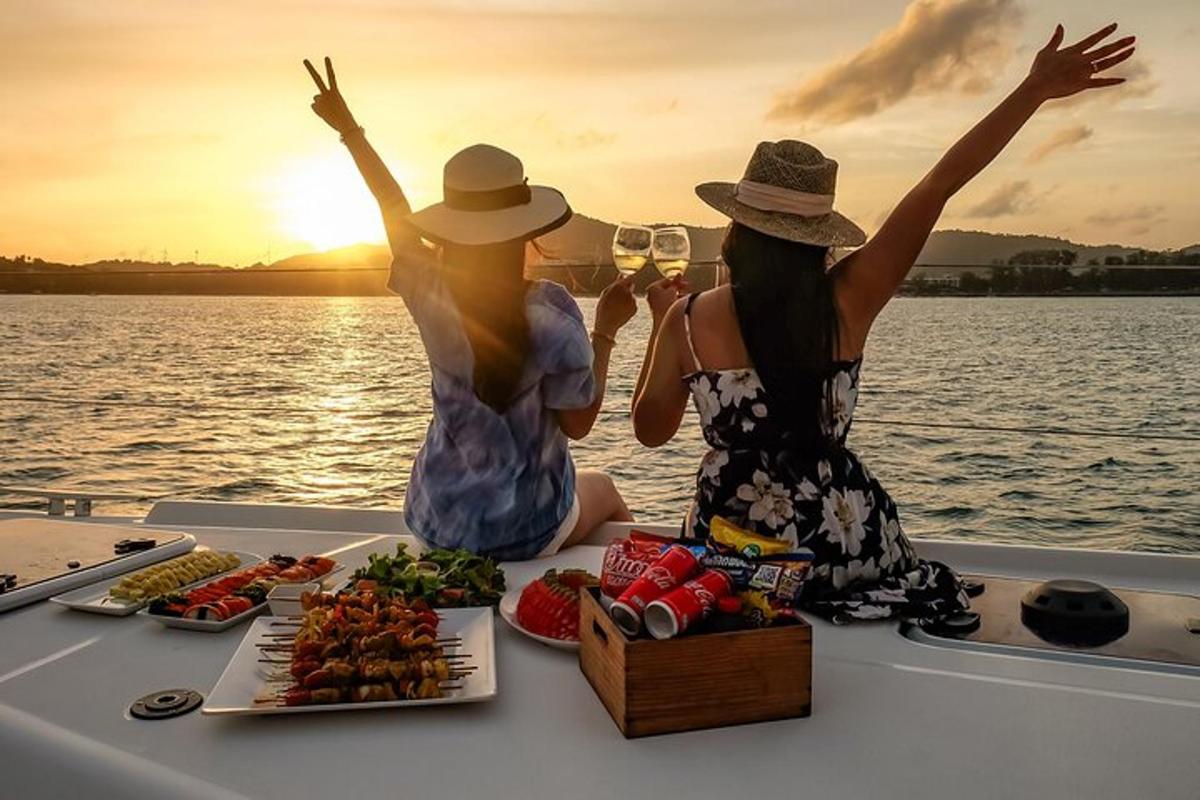 two women sitting on a boat with food on a table