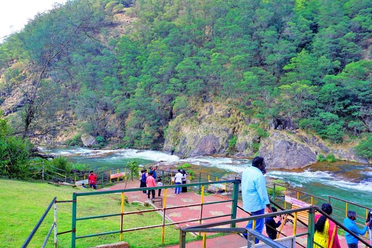 a group of people standing on a bridge near a river