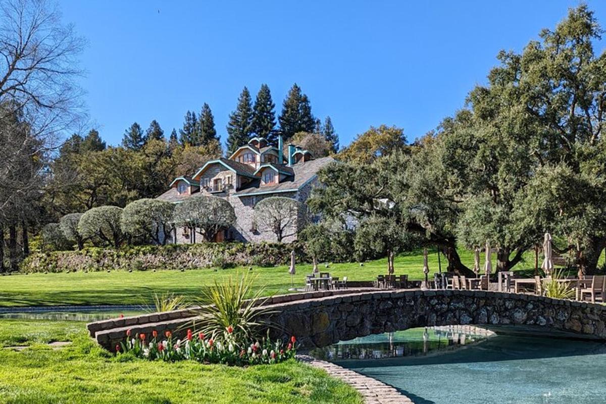 a large house with a bridge over a river
