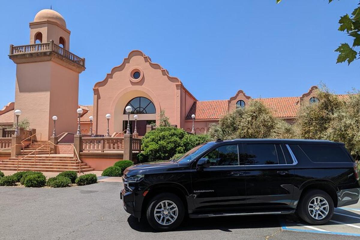 a black suv parked in front of a building
