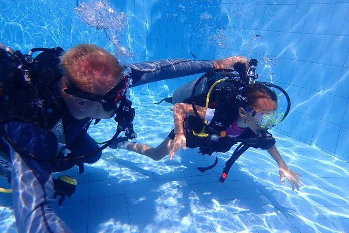 two people in the water in a swimming pool