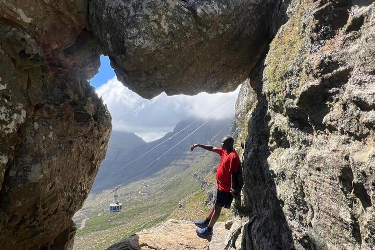 a man is standing inside of a rock formation