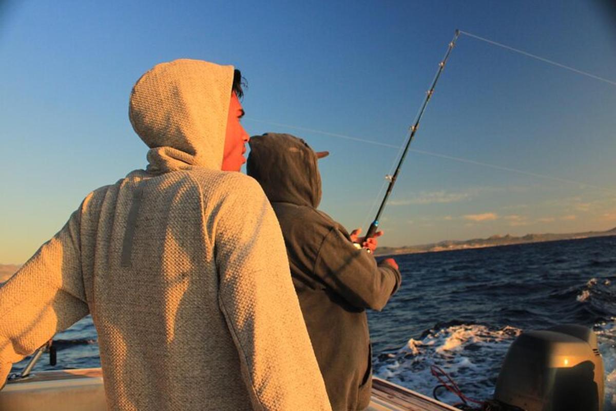 a man and a child fishing on a boat