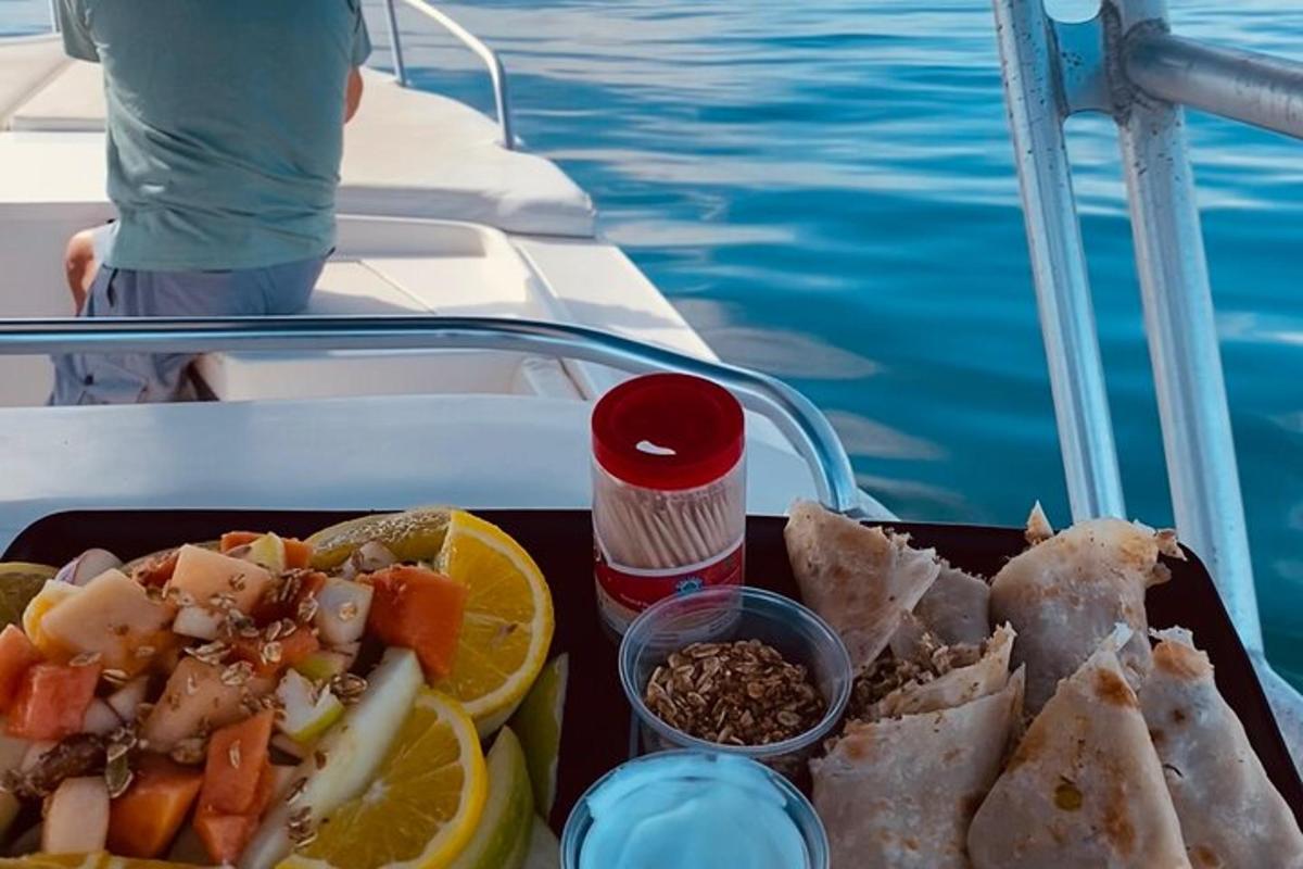 a tray of food on a boat next to the water