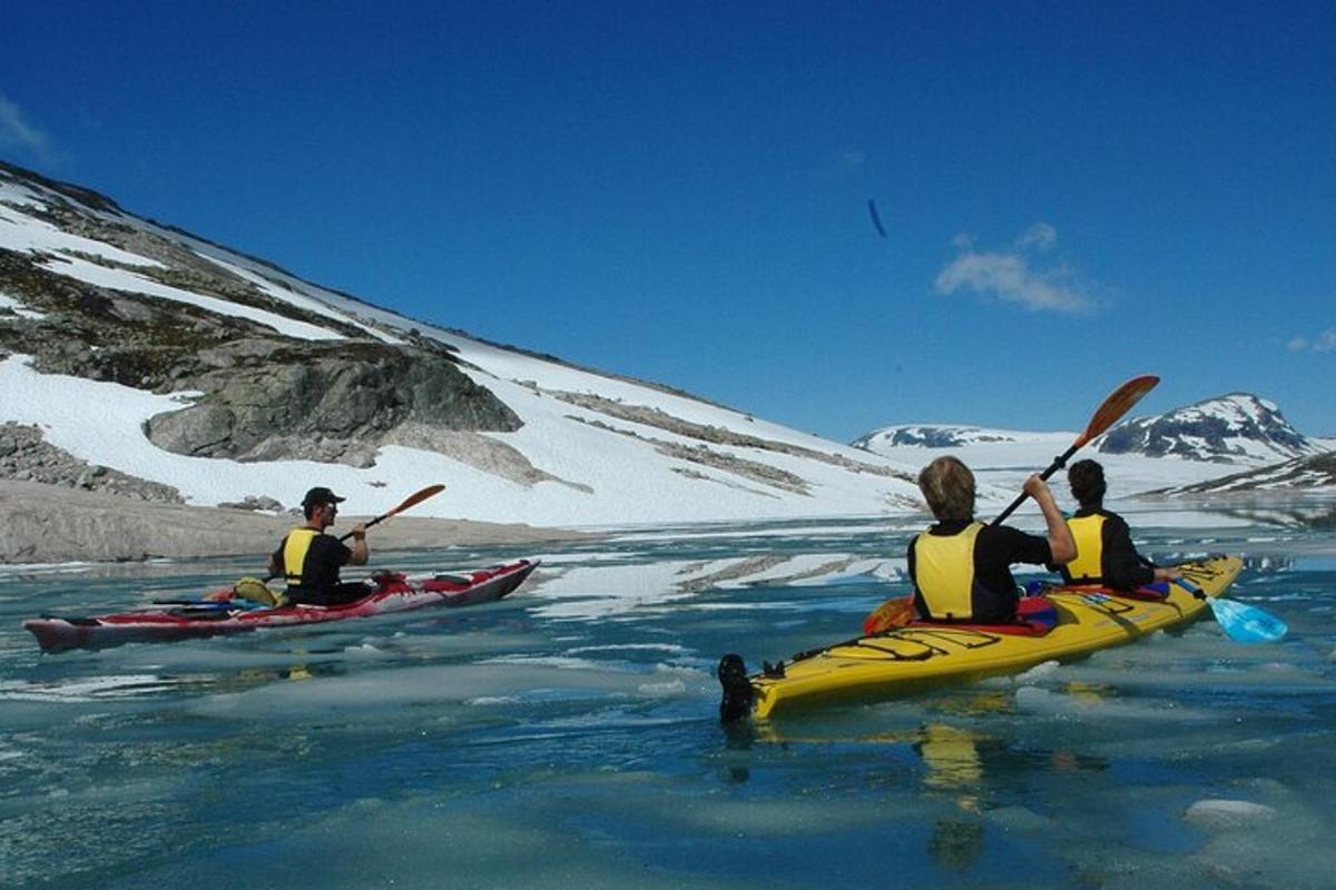 three people in kayaks on a body of water
