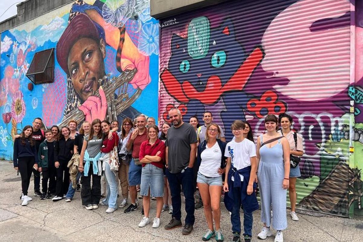 a group of people standing in front of a mural