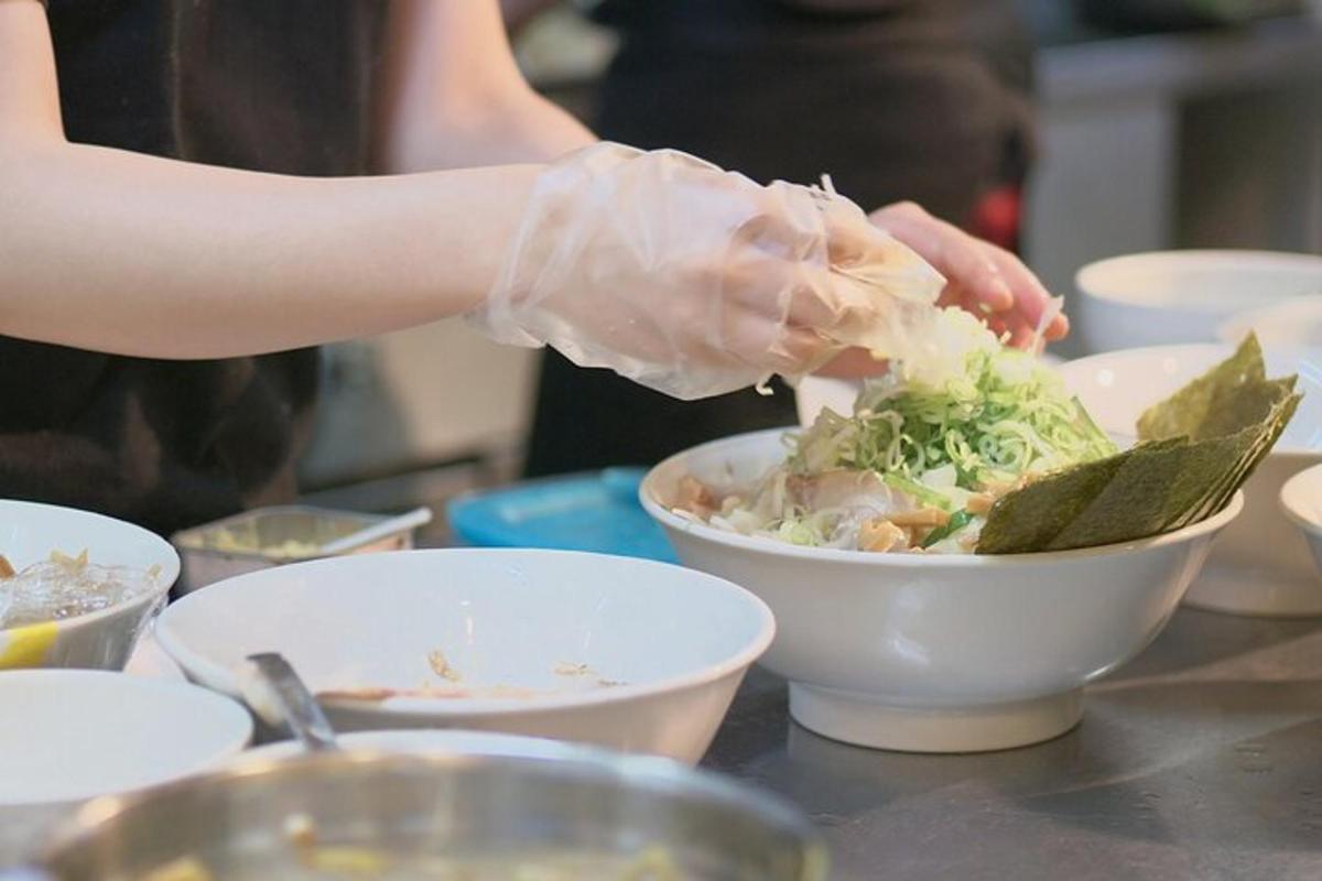 a person in gloves preparing a bowl of food