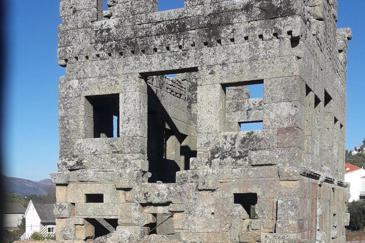 an old stone building with windows on top of it