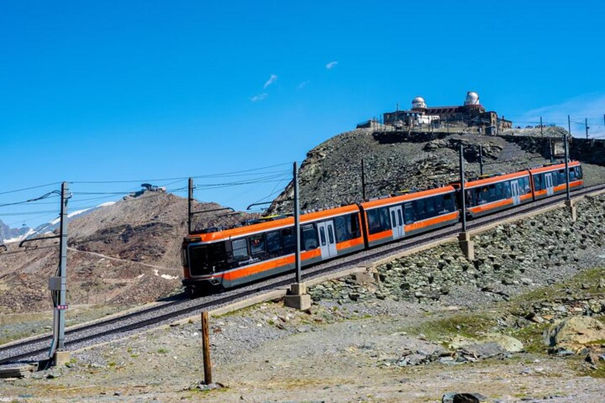 a train is on the tracks near a hill