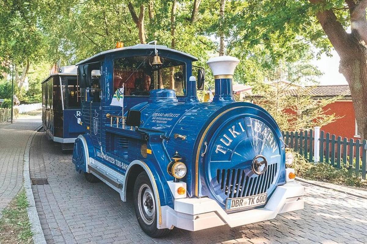 a blue train engine is parked on a street