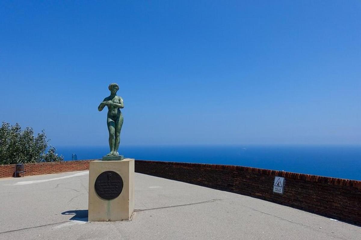 a statue of a woman on a pedestal near the ocean