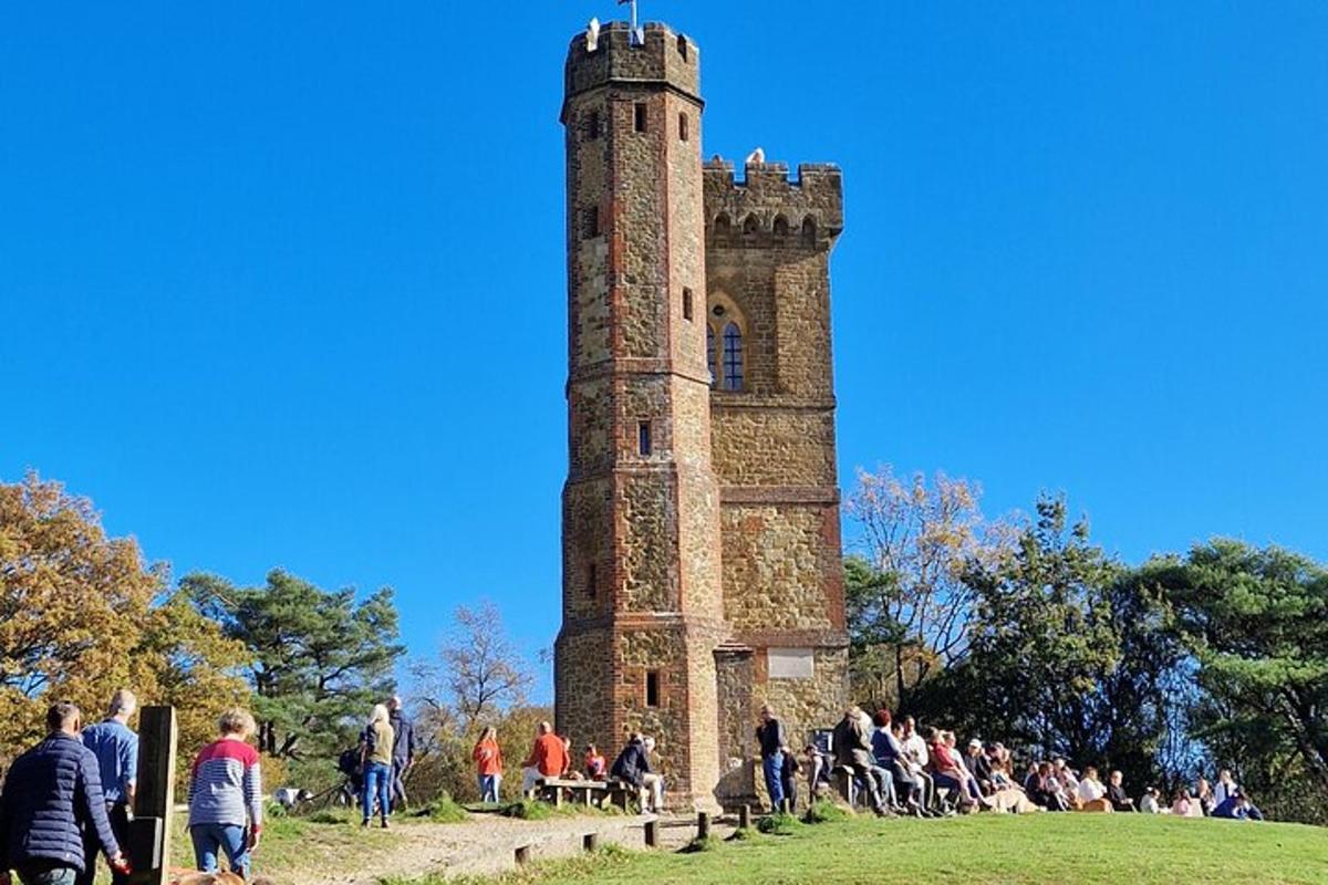 Un grupo de personas de pie alrededor de una torre alta.