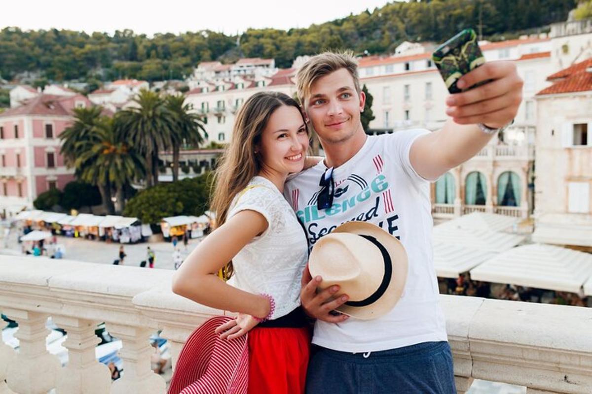 a man and a woman taking a picture with a cell phone